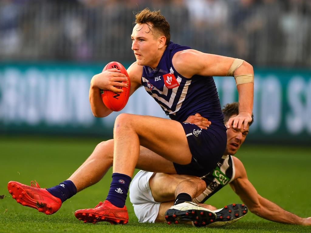 PERTH, AUSTRALIA - AUGUST 25: Brennan Cox of the Dockers is tackled by Levi Greenwood of the Magpies during the 2018 AFL round 23 match between the Fremantle Dockers and the Collingwood Magpies at Optus Stadium on August 25, 2018 in Perth, Australia. (Photo by Daniel Carson/AFL Media/Getty Images)