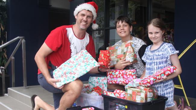 At the 2022 Cairns Community Christmas Lunch, Ken Frost Homes gifts for children were delivered by Alex Laughton, son Liam and daughter Ivy. Picture: Alison Paterson