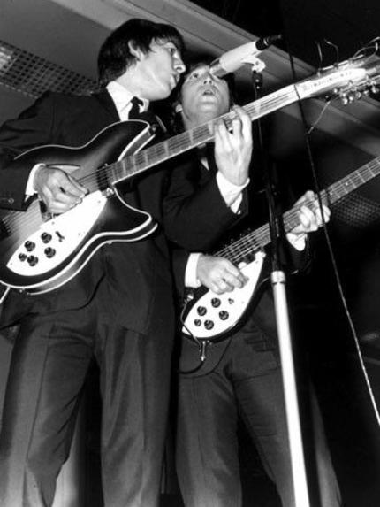 George Harrison and John Lennon on stage during one of the concerts at Festival Hall. Picture: Herald Sun Image Library