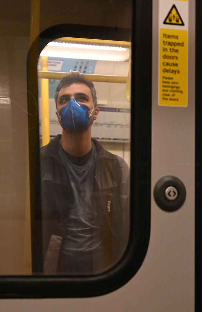 A man rides the Tube in London. British PM Boris Johnson has invoked stricter public measures to battle coronavirus. Picture: AFP