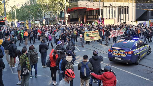 Protesters close off the corner of La Trobe and Swanston streets. Picture: Jason Edwards