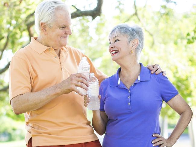 Active senior couple with  outdoors taking a break after some jogging