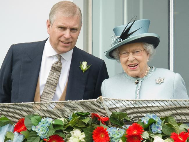 Prince Andrew, the Duke of York, speaks to Queen Elizabeth II during Derby day at the Epsom Derby in 2013. Picture: AFP