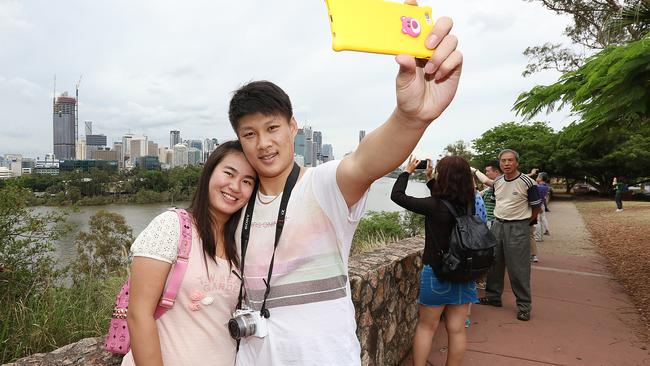 Chinese tourist Ji Huang and her boyfriend Zheng Guo both from Shanghai pictured here at the Kangaroo Point Cliffs in Brisbane 16/12/2015. Pictures: Jack Tran