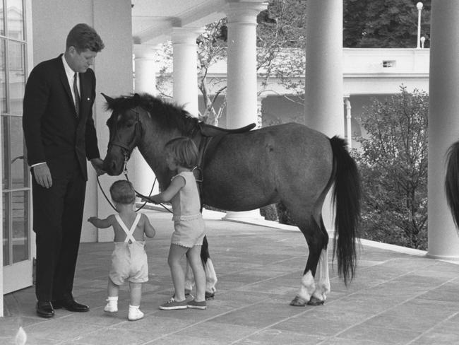 American President John F. Kennedy and his children, John and Caroline, play with pony Macaroni, outside the White House's Oval Office, Washington DC, June 22, 1962. Picture: Photoquest/Getty Images