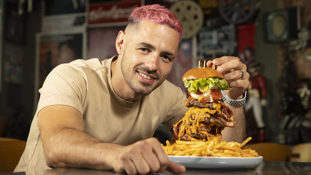 Former Chuck Wagon owner James Tsimopoulos in 2021 with his Commando Burger. Picture: Simon Cross