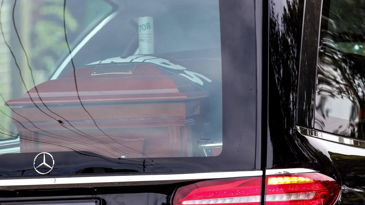 The hearse carrying Shane Warne leaves the ground. Picture: Ian Currie