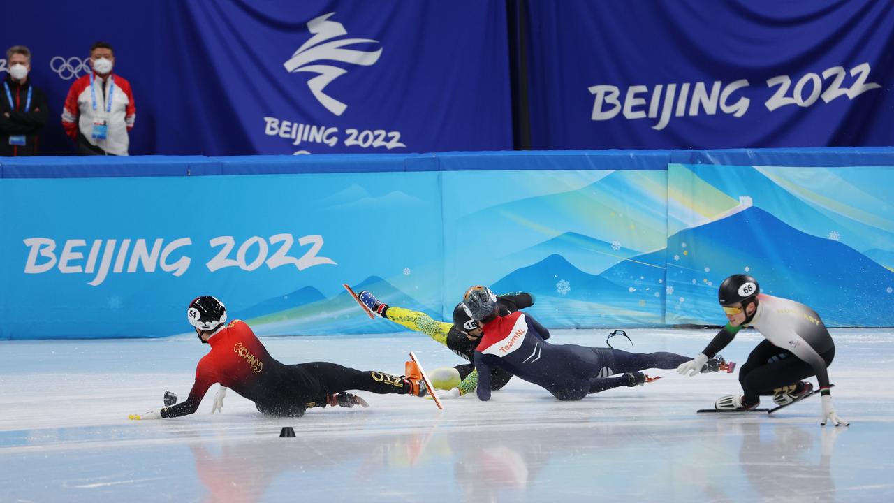 Ziwei Ren of Team China, Brendan Corey of Team Australia and Itzhak de Last of Team Netherlands crash as John-Henry Krueger skates by. Picture: Getty Images.