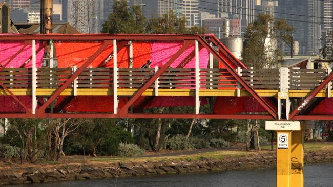 Cyclists cross the old stock bridge over the Maribyrnong River as they ride along the Maribyrnong River Trail.