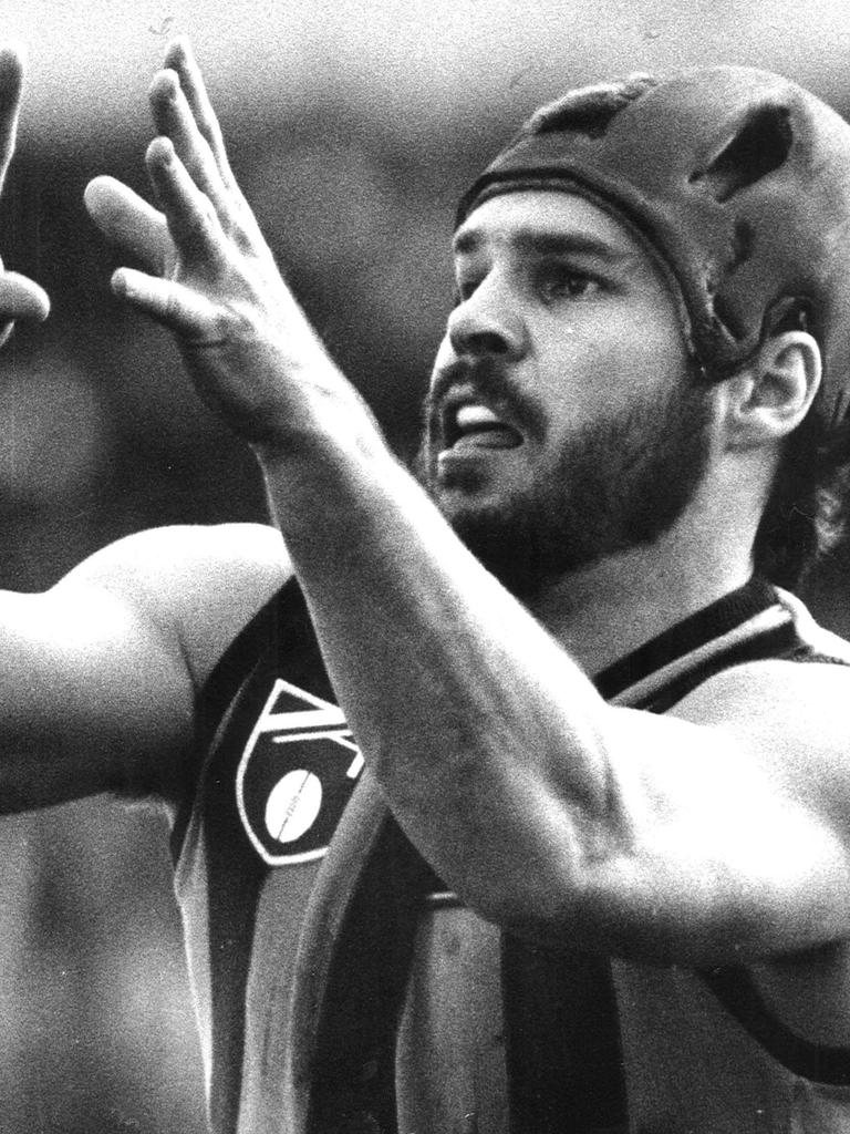 Hawthorn legend Jason Dunstall with his famous headgear in 1990.