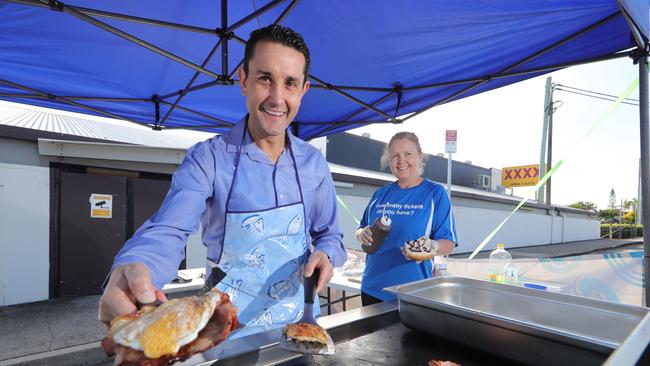 David Crisafull's local bowls club at Paradise Point has restarted its BBQ and takeaway coffee each morning. David cooking up a storm at BBQ with bowls club staff member Vicki Skinner. Picture Glenn Hampson