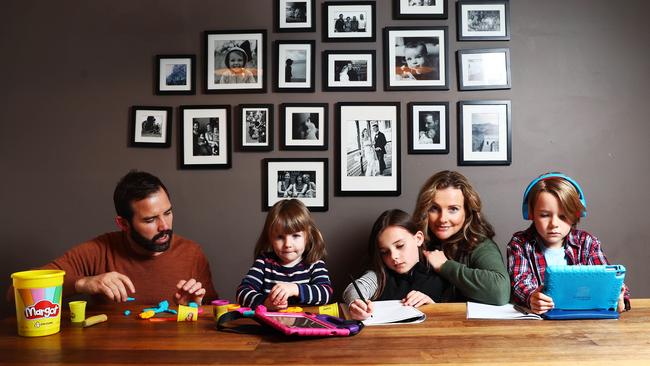 Mat and Kate Tinkler with their kids Margot, 3, Audrey ,9, and Flynn ,7, who will resume remote learning when the Victorian term commences next week. Picture: Aaron Francis