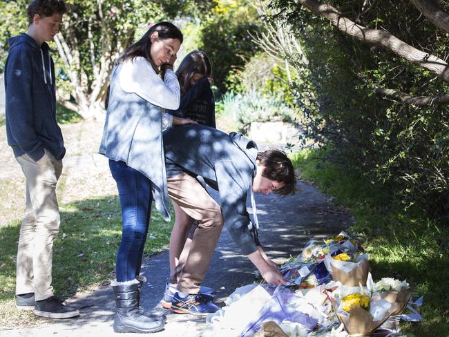 People pay tribute outside the house where Jack and Jennifer Edwards were shot dead. Picture: Jenny Evans