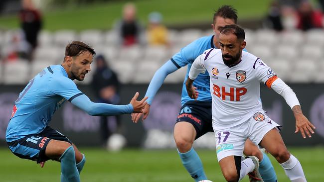 Glory skipper Diego Castro (right) takes on Sydney FC pair Milos Ninkovic and Joel King. Picture: Scott Gardiner/Getty Images