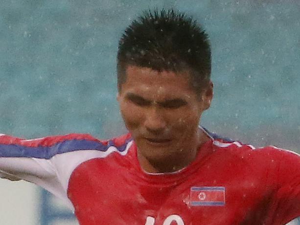 Uzbekistan’s Vitaliy Denisov, right, tackles North Korea’s Pak Kwang Ryong during the first round soccer match of the AFC Asia Cup between Uzbekistan and North Korea in Sydney, Australia, Saturday, Jan. 10, 2015.(AP Photo/Rob Griffith)