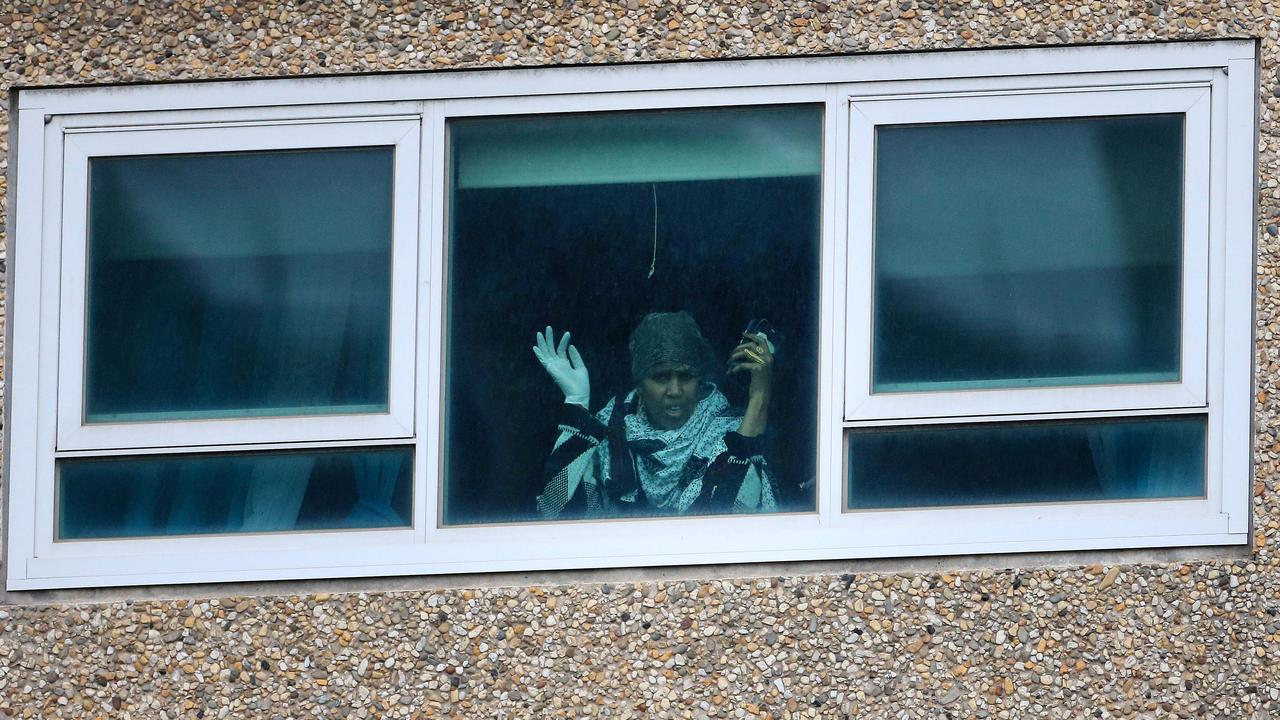 A resident stuck in a ‘hard’ lockdown in Melbourne’s housing commission units looks down at the road. Picture: Sarah Matray