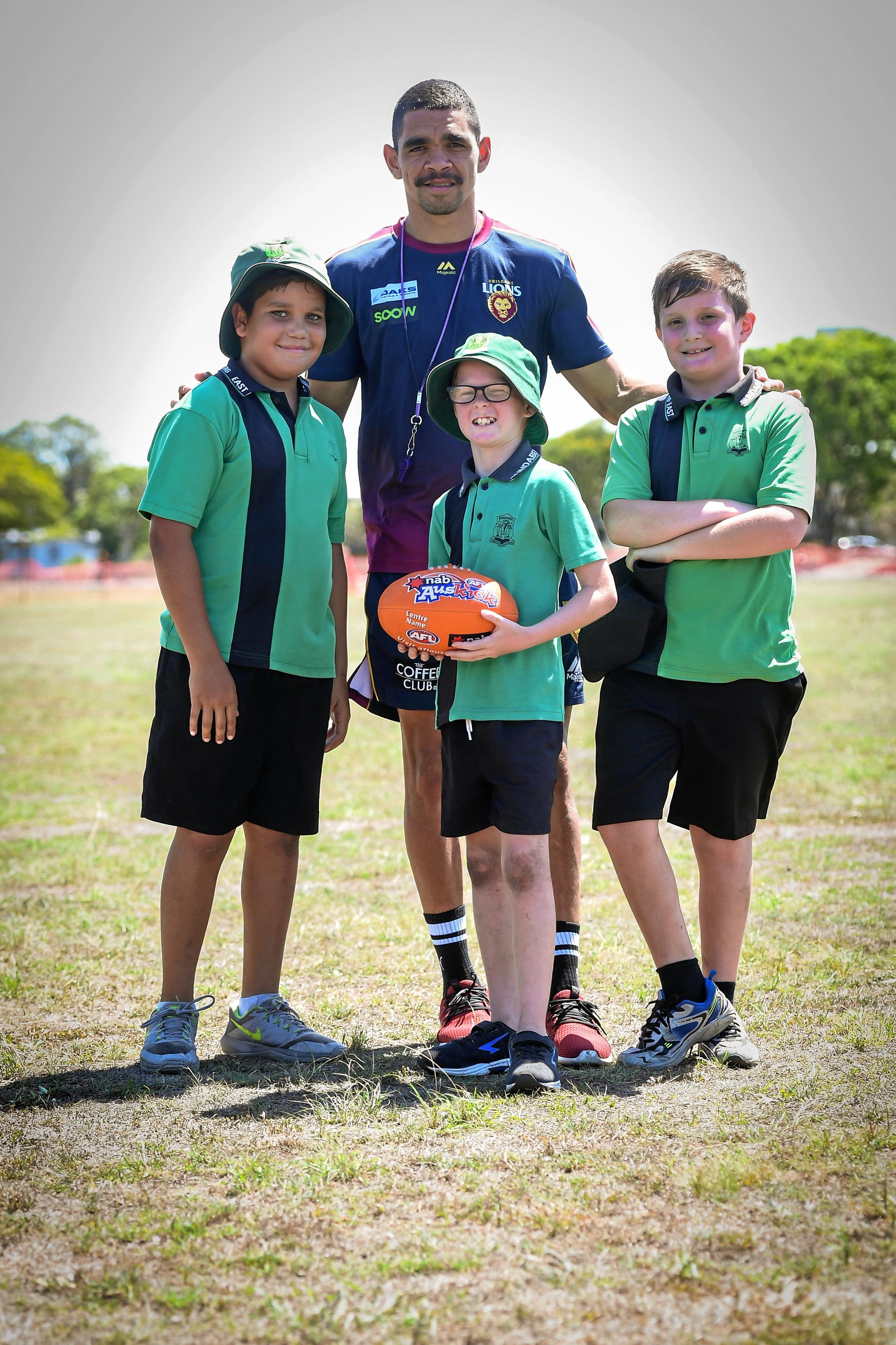 Darius Freeman, Shane McDonald and Ryan Hayhoe with their hero, Charlie Cameron from the Brisbane Lions. Picture: Brian Cassidy