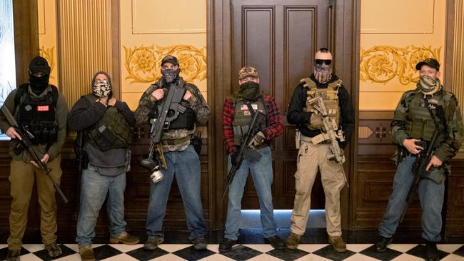 A militia group with no political affiliation from Michigan stands in front of the governor’s office after protesters occupied the state capital building in April. Picture: Reuters