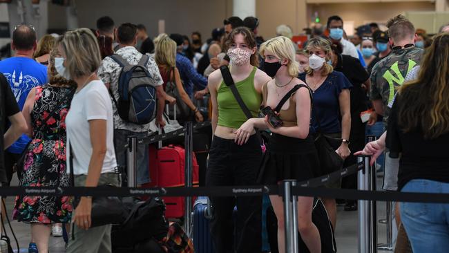 Travellers crowd the check-in desks at Sydney airport on Friday in a desperate race to get out of town. Picture: Getty