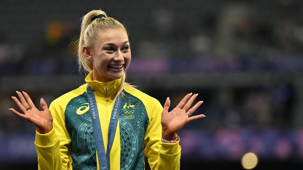 Australia's Jessica Hull celebrates on the podium after competing in the women's 1500m final.