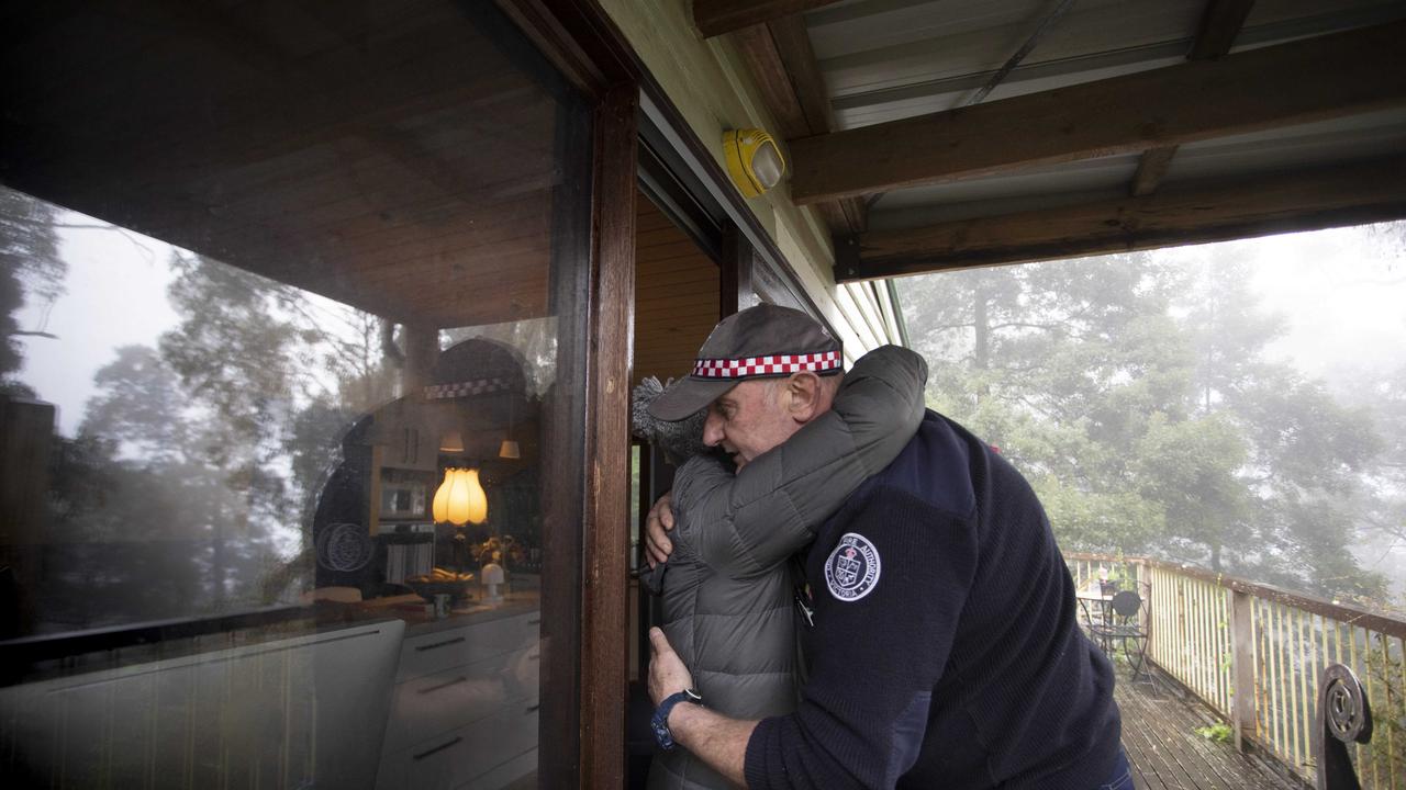 Kalorama resident Alison hugs CFA volunteer Shayne O'Dwyer as he makes house checks following a wild storm. Picture: Arsineh Houspian