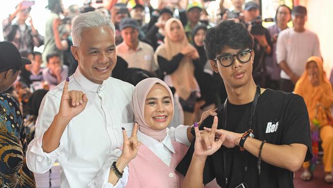 Presidential candidate and former Central Java governor Ganjar Pranowo, left, with his wife Siti Atiqoh Supriyanti and son Muhammad Zinedine Alam Ganjar. Picture: AFP.