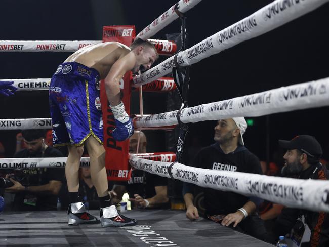 Wilson has a crack at Dib’s corner, including trainer Billy Hussein (white hat) after their first fight last year. Pictures: No Limit Boxing/Gregg Porteous