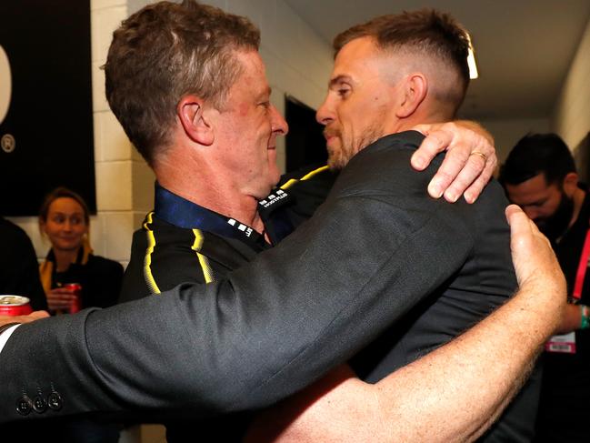 MELBOURNE, AUSTRALIA - SEPTEMBER 28: Damien Hardwick, Senior Coach of the Tigers and Brett Deledio of the Giants embrace after the 2019 Toyota AFL Grand Final match between the Richmond Tigers and the GWS Giants at the Melbourne Cricket Ground on September 28, 2019 in Melbourne, Australia. (Photo by Michael Willson/AFL Photos via Getty Images)