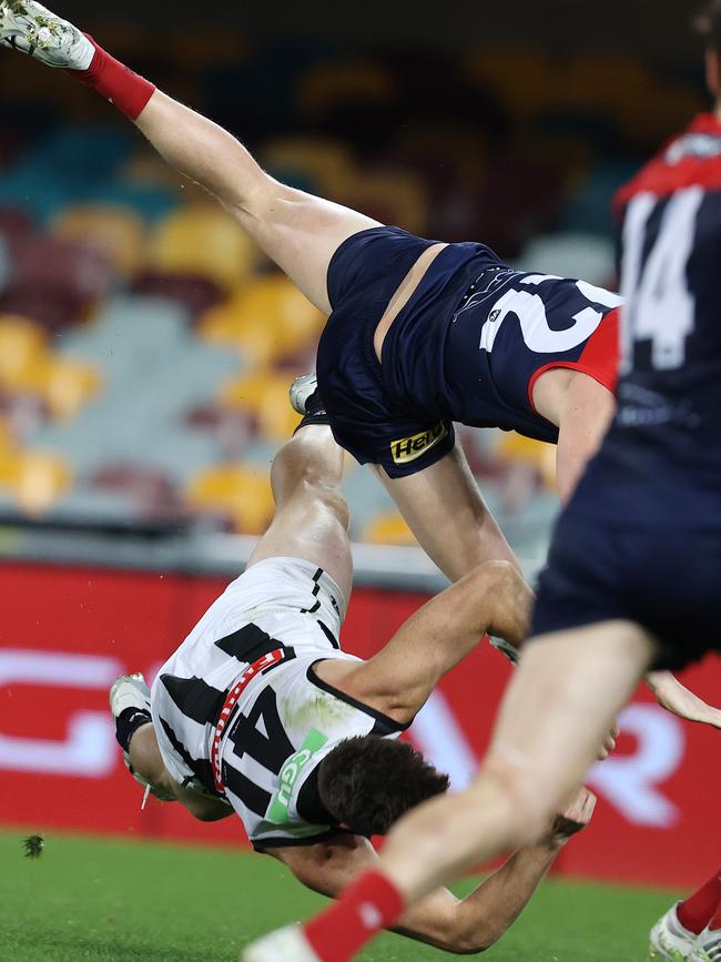 Magpie Brody Mihocek flies though the air after the heavy collision.