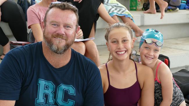 Rocky City Swimming Club coach Shane Kingston with swimmers Amelie Smith and Maddy Watson.