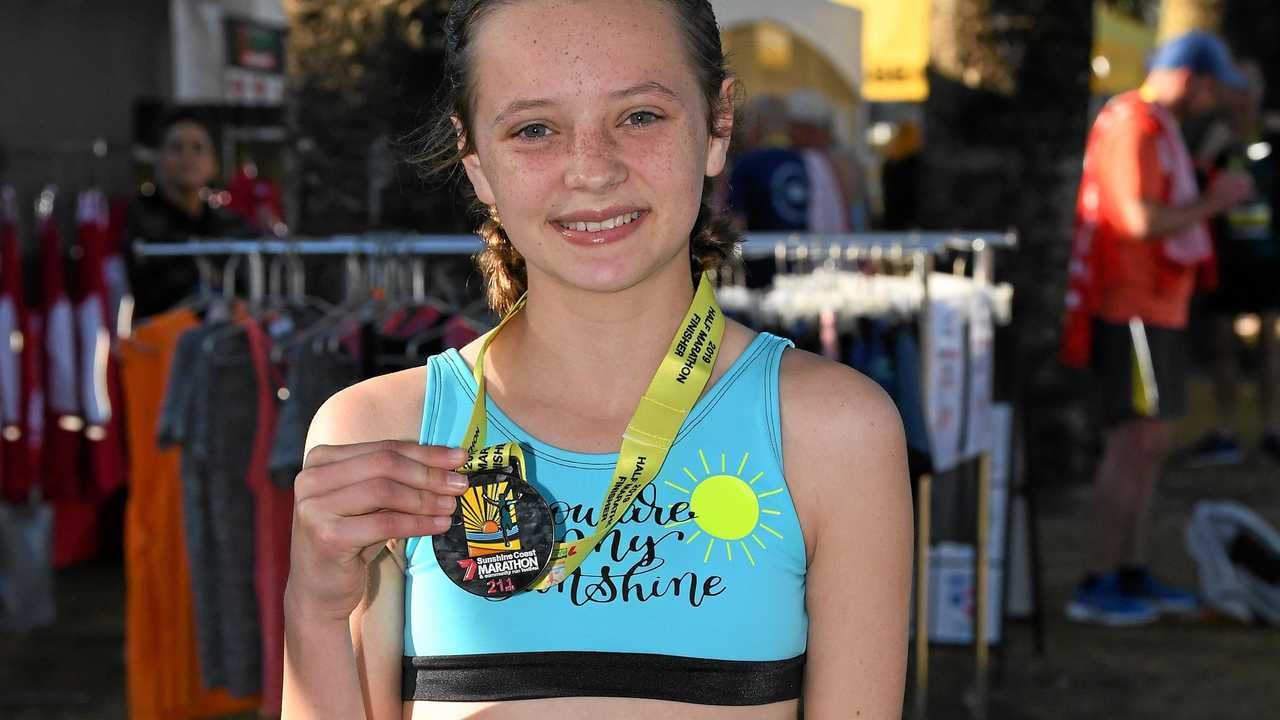STAR WILL SHINE BRIGHTER: Loghan Gonzales shows off her medal after she finished first Sunshine Coast Marathon. Picture: Warren Lynam