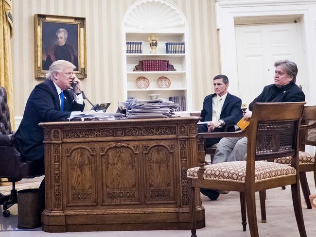 Donald Trump during a fiery phone call with Malcolm Turnbull as former National Security Adviser Michael Flynn and former chief strategist, Steve Bannon watch on. Picture: AFP