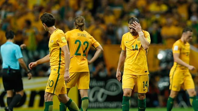 Socceroos Robbie Kruse, Jackson Irvine and James Troisi look dejected after Japan's first goal during Australia’s 2-0 FIFA World Cup qualifying loss at Saitama Stadium (Getty Images)