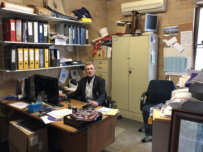 Former Manly Life Saving Club president Tony Bonner at his desk.