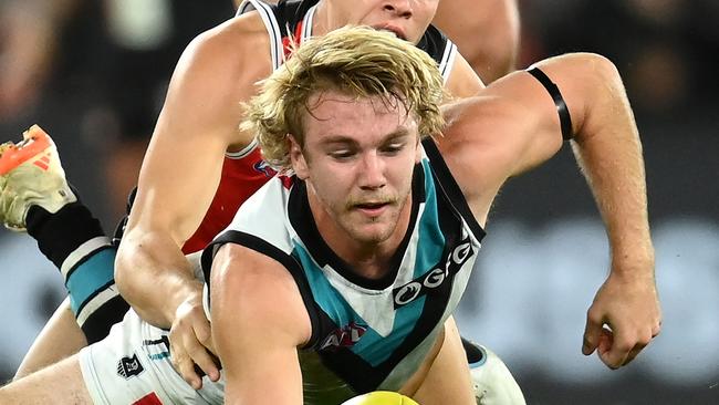 MELBOURNE, AUSTRALIA - APRIL 28: Jason Horne-Francis of the Power handballs whilst being tackled by Marcus Windhager of the Saints during the round seven AFL match between St Kilda Saints and Port Adelaide Power at Marvel Stadium, on April 28, 2023, in Melbourne, Australia. (Photo by Quinn Rooney/Getty Images)