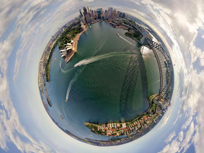 **PLEASE USE CORRECT BYLINE** PIC FROM AIRPANO / CATERSNEWS - (PICTURED: - Sydney and the Sydney Opera House, Australia) Some of the worlds most iconic cities have been photographed as youve never seen them before in the shape of tiny round planets. By using a pioneering method of aerial photography, each location can be now seen at a full 360 degree angle. After some skilful manipulation on Photoshop known technically as stereographic projection, each sweeping panorama is then turned into a small circular shaped image. Whether its the Eiffel Tower, The Empire State Building or the Shanghai Skyline, each image manages to show hundreds of miles of city landscape. SEE CATERS COPY