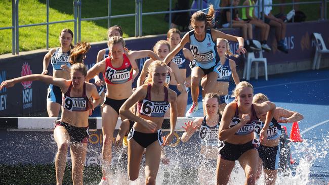 Zoe Manning, left, Kiera Moore and Tyla Lumley in the steeplechase at an Australian Athletic Track and Field Championship