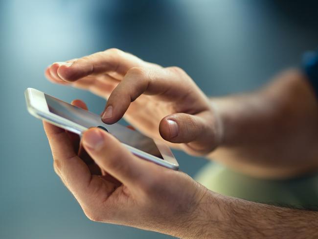 Generic Male hands typing on smartphone. Picture: Istock