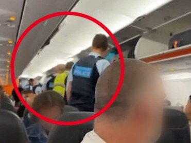 Australian Federal Police officers were called in to escort four men from a Jetstar flight when it arrived at Melbourne Airport from Brisbane on Monday night. Credit: 7NEWS