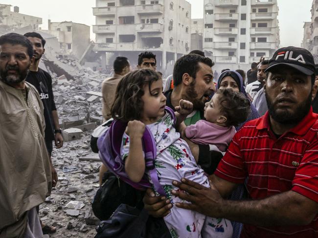 Palestinians flee after an Israeli air strike in Gaza. Picture: Mohammed Abed (AFP)