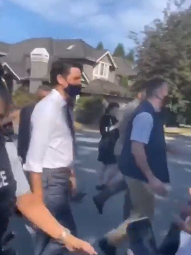 As he walked the street furious anti-vaxxers screamed insults. Picture: Twitter