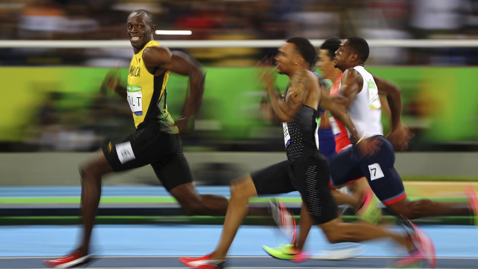 In this image released Monday Feb. 13, 2017, by World Press Photo titled "Rio's Golden Smile" by photographer Kai Pfaffenbach, Thomson Reuters, which won third prize in the Sports, Singles, category of the World Press Photo contest shows Usain Bolt of Jamaica smiling as he looks back at his competition, whilst winning the 100-meter semifinal sprint, at the 2016 Olympics in Rio de Janeiro, Brazil. Bolt is regarded as the fastest human ever timed. He is the first person to hold both the 100-meter and 200-meter world records since fully automatic time became mandatory. (Kai Pfaffenbach, Thomson Reuters, World Press Photo via AP)