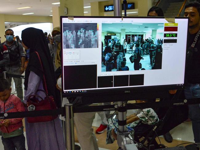 Passengers travelling through the Sultan Iskandar Muda International Airport in Indonesia being scanned to detect body temperatures and whether they are sick. Picture: Chaideer Mahyuddin/AFP