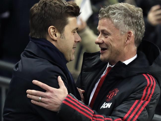 Manchester United caretaker manager Ole Gunnar Solskjaer, right, greets Tottenham manager Mauricio Pochettino, left, prior to the English Premier League soccer match between Tottenham Hotspur and Manchester United at Wembley stadium in London, England, Sunday, Jan. 13, 2019. (AP Photo/Matt Dunham)