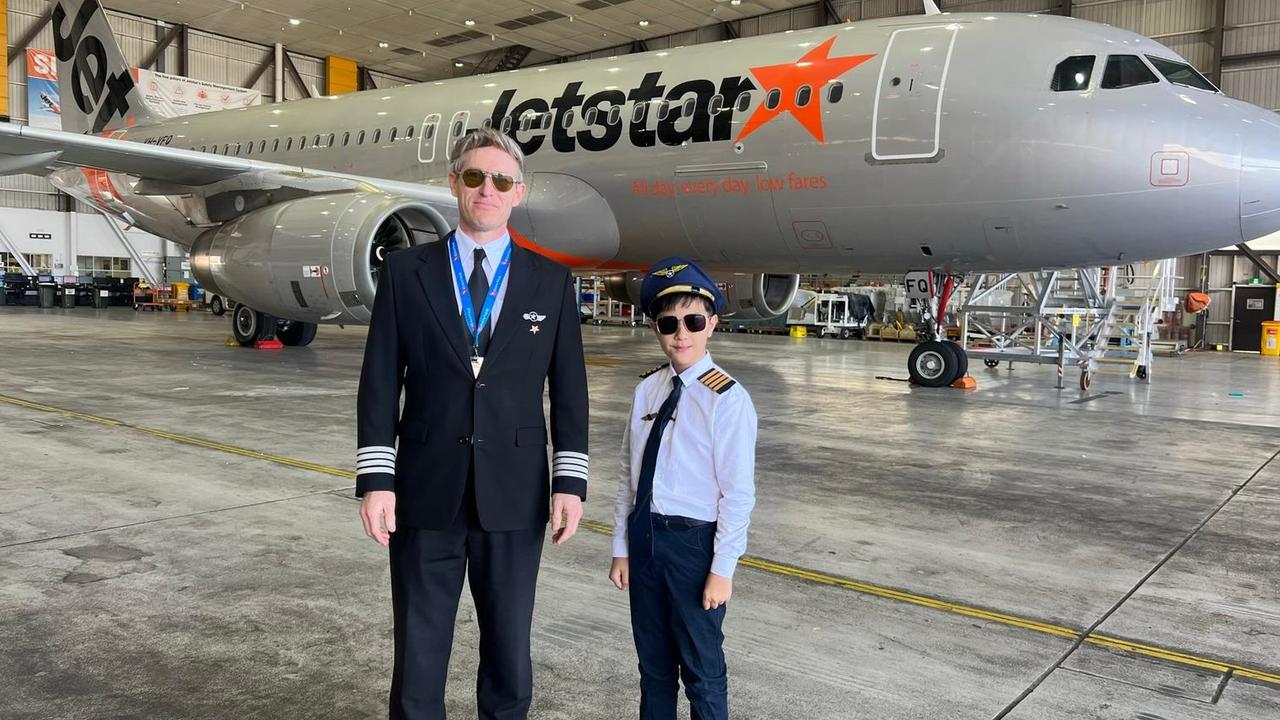 Seb and Captain Hadrian Zerbe in the Jetstar hanger. Picture: Supplied