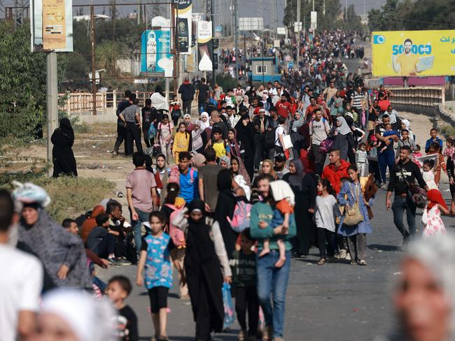 Palestinians walk down a road as they flee Gaza City and other parts of northern Gaza towards the southern areas on November 8, 2023 amid ongoing battles between Israel and the Palestinian Hamas movement. (Photo by MOHAMMED ABED / AFP)
