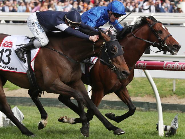 Jockey Pat Cosgrove and Best Solution (right) edge out Homesman to win the Caulfield Cup.