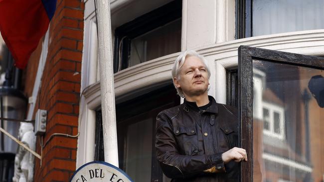 Julian Assange greets supporters outside the Ecuadorean embassy in 2017. Picture: AP.