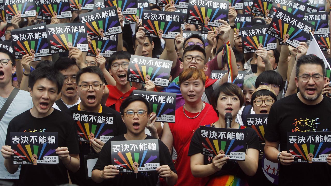 The people have spoken out in firm support of the same-sex marriage. The signs read ''Vote Can't Be Defeated.'' Picture: AP/Chiang Ying-ying