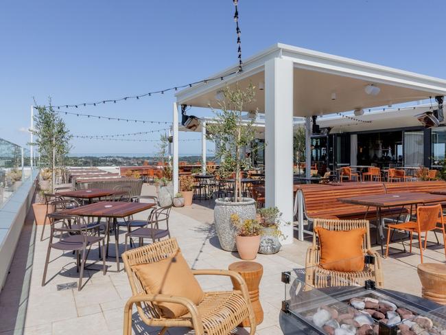 Outdoor view of Lady Banks rooftop bar during daylight hours, with no patrons seated.